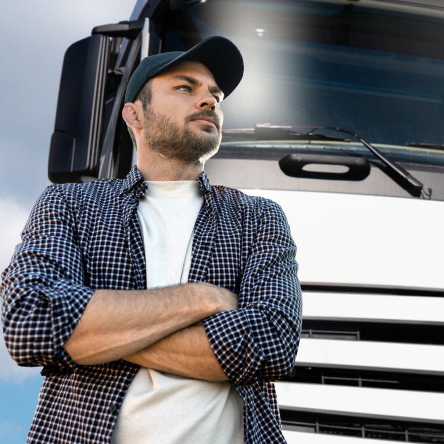 Truck driver in front of vehicle