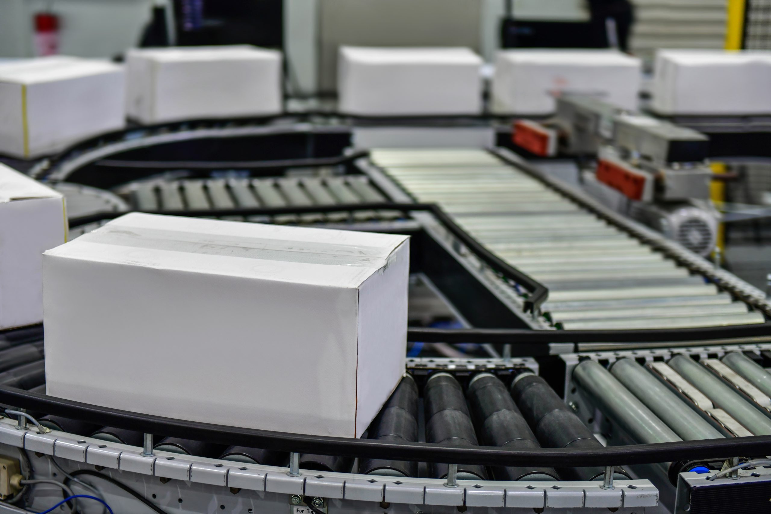 White cardboard boxes on airport conveyor belt