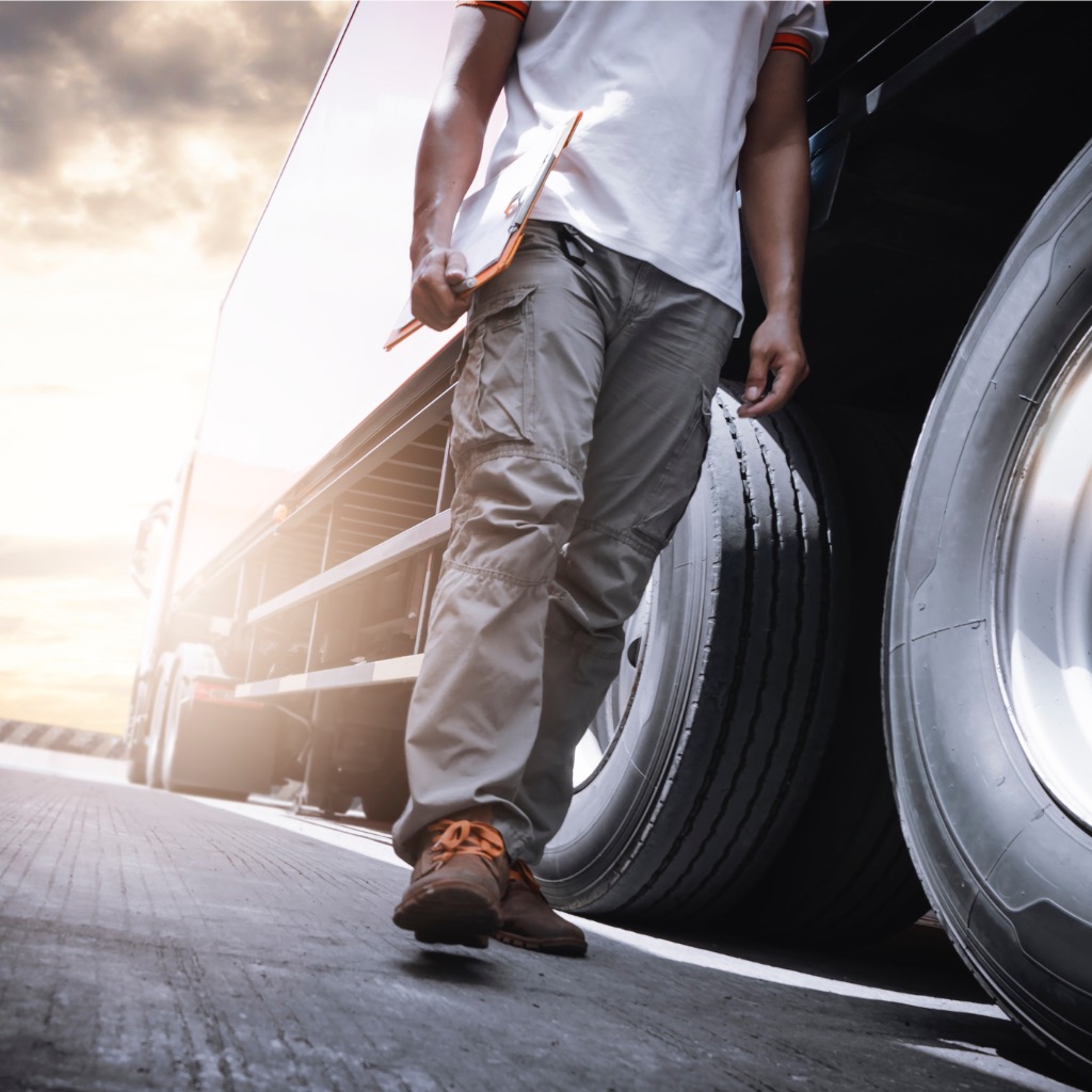 Truck driver walking by rig